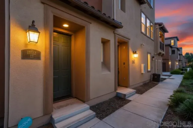 a view of a room that has a large door and wooden door