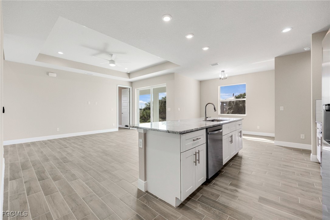 1346 Radio Loop LaBelle, FL 33935 - Photo 11 of 27 a large kitchen with granite countertop a large counter top space stainless steel appliances and cabinets
