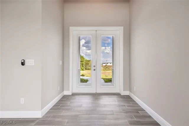 an empty room with window and wooden floor