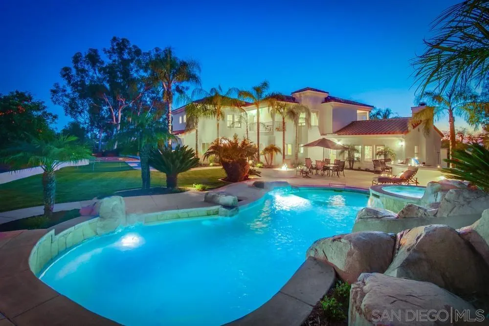 14399 Blue Sage Road Poway, CA 92064 - Photo 1 of 70 a view of a swimming pool with a yard and sitting area