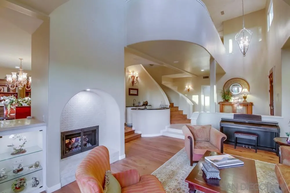14399 Blue Sage Road Poway, CA 92064 - Photo 20 of 70 a living room with furniture and a chandelier