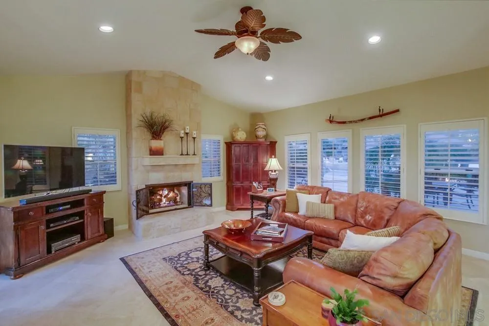 14399 Blue Sage Road Poway, CA 92064 - Photo 21 of 70 a living room with fireplace furniture and a flat screen tv