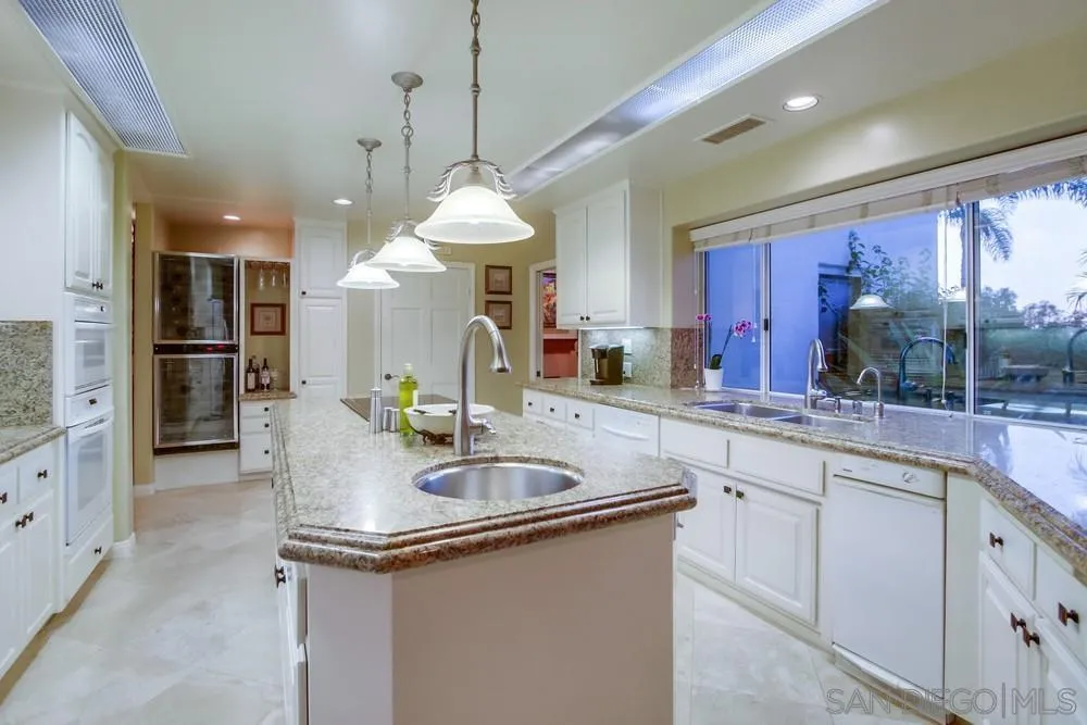 14399 Blue Sage Road Poway, CA 92064 - Photo 27 of 70 a kitchen with stainless steel appliances granite countertop a sink a counter space and cabinets