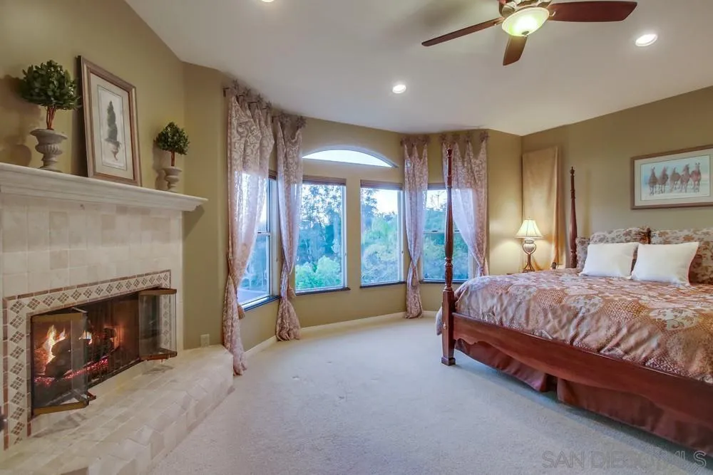 14399 Blue Sage Road Poway, CA 92064 - Photo 34 of 70 a spacious bedroom with a bed and a fireplace