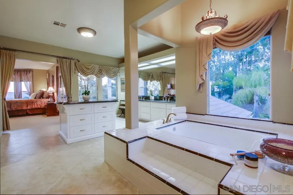 14399 Blue Sage Road Poway, CA 92064 - Photo 37 of 70 a spacious bathroom with a double vanity sink a mirror and a shower