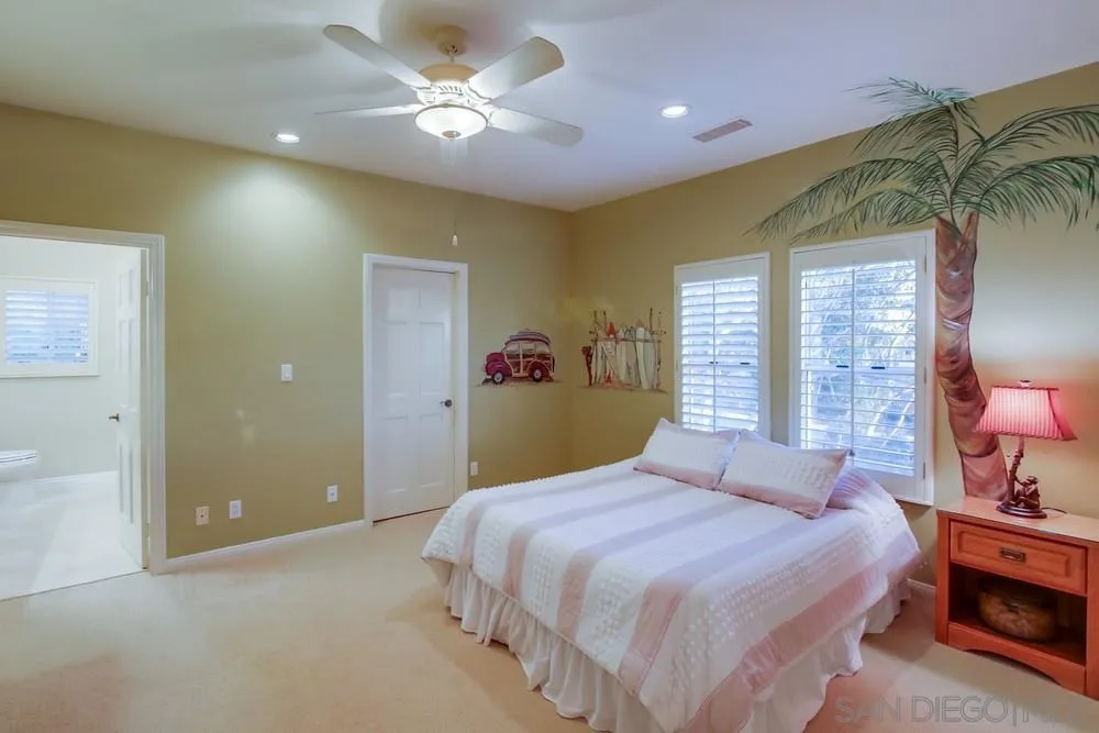 14399 Blue Sage Road Poway, CA 92064 - Photo 46 of 70 a bedroom with a bed and a chandelier