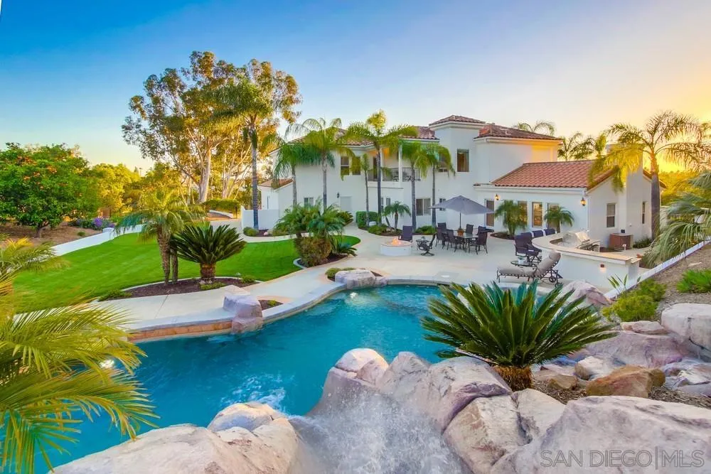 14399 Blue Sage Road Poway, CA 92064 - Photo 59 of 70 a view of a swimming pool with a table and chairs