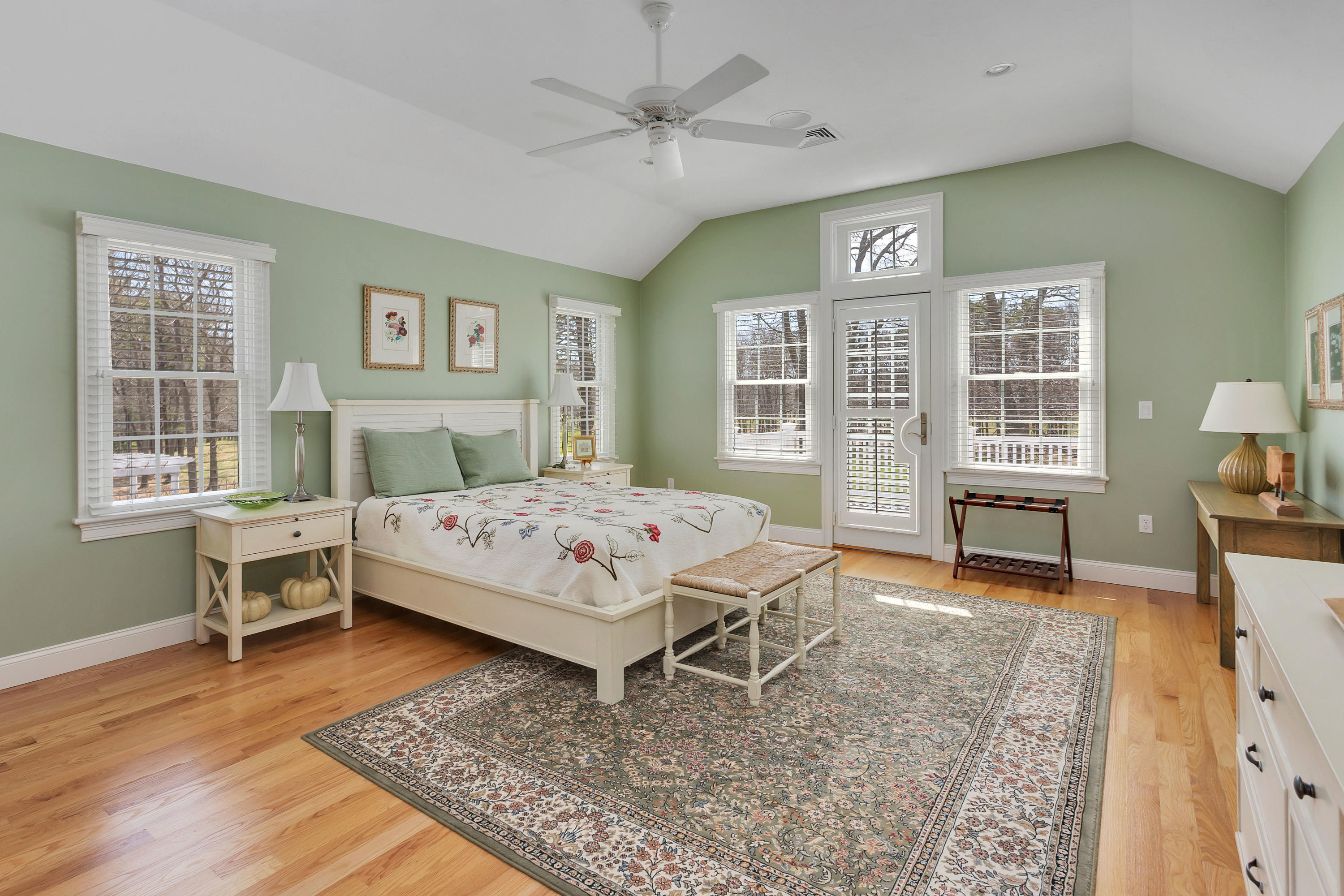 10 Open Space Drive Sandwich, MA 02563 - Photo 29 of 49 a bedroom with a large bed a chandelier and windows