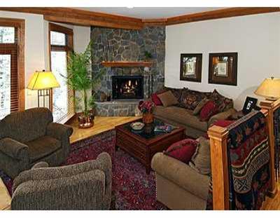 2350 Bald Mountain Road, Unit 3 Vail, CO 81657 - Photo 4 of 8 a living room with furniture a fireplace and a large window