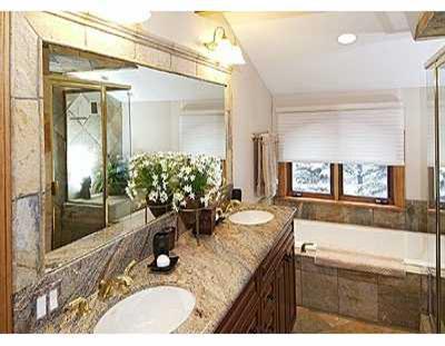 2350 Bald Mountain Road, Unit 3 Vail, CO 81657 - Photo 6 of 8 a bathroom with a granite countertop sink a mirror and a shower