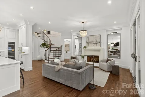 a living room with fireplace furniture and a wooden floor