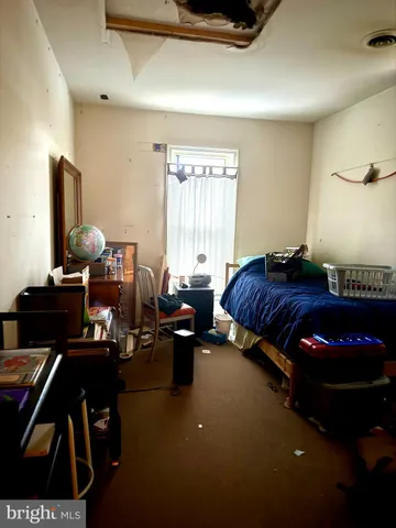 a living room with furniture a rug and a window