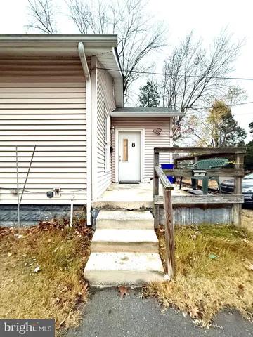 a view of a white house with swimming pool in front of it
