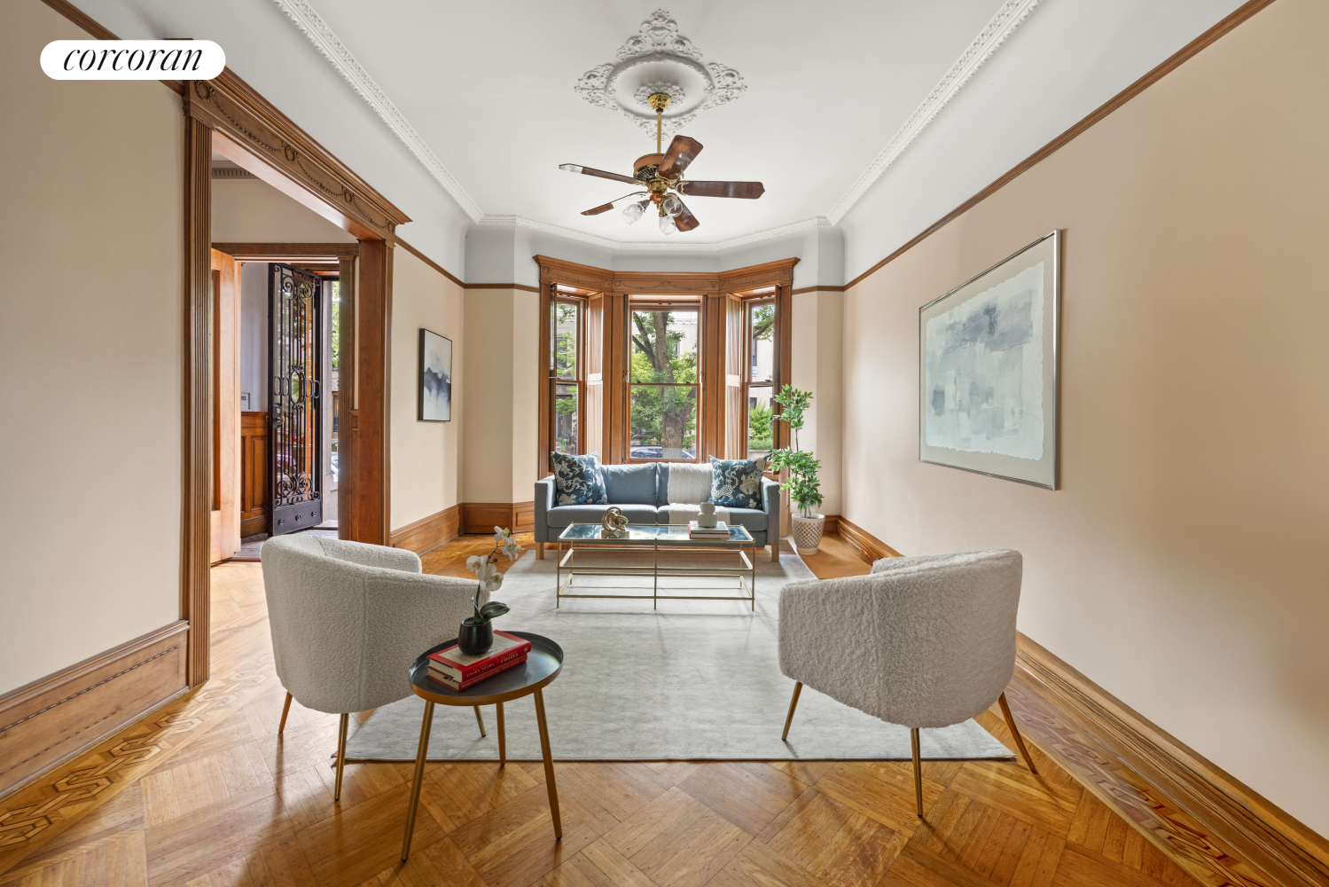 a living room with furniture a chandelier and a large window