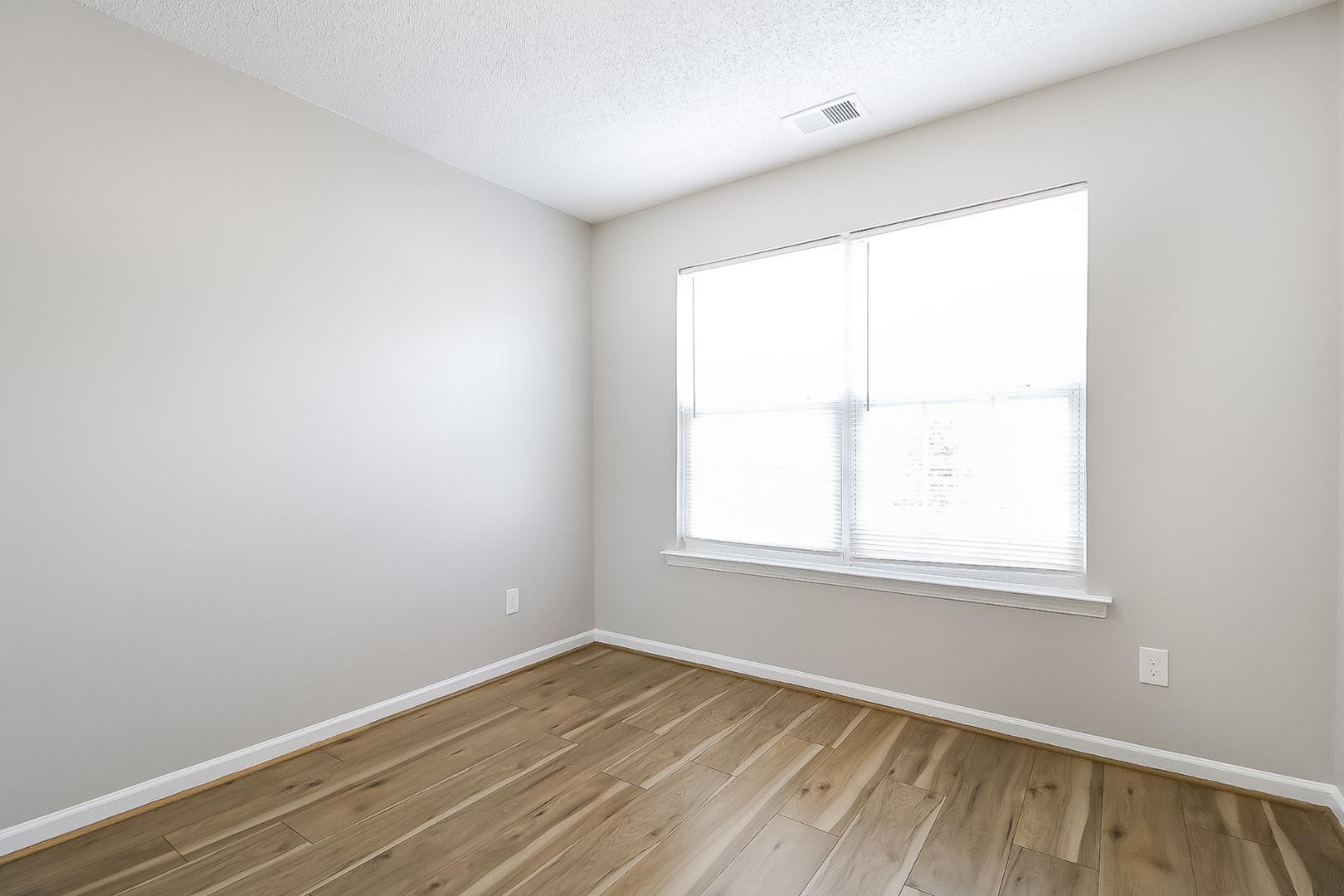 5900 Wessel Way Raleigh, NC 27610 - Photo 14 of 17 an empty room with wooden floor and windows