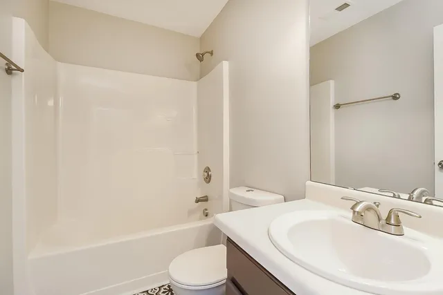 a bathroom with a toilet a sink and a bathtub