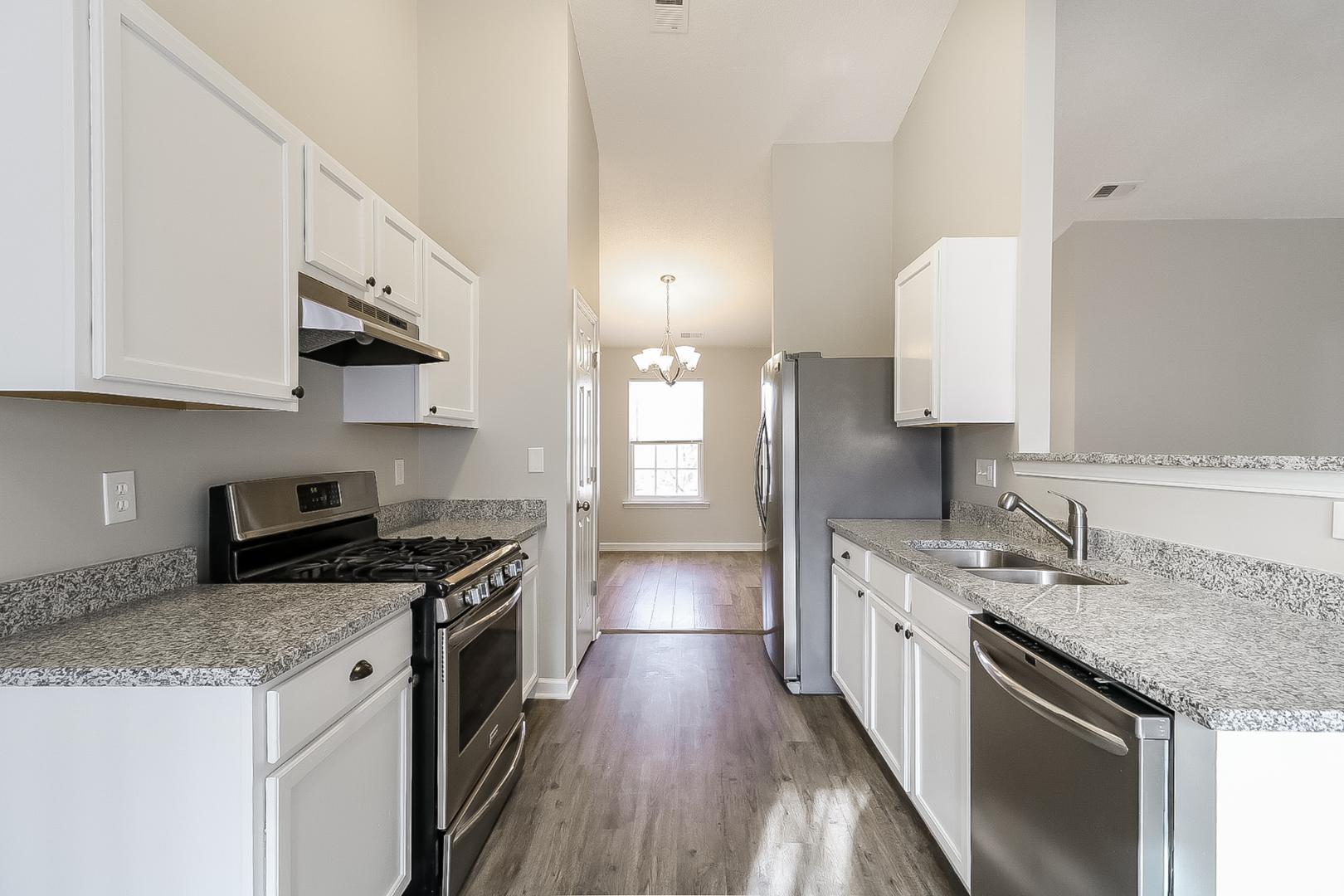 5900 Wessel Way Raleigh, NC 27610 - Photo 7 of 17 a kitchen with a sink stove top oven and cabinets