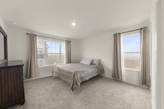 a spacious bedroom with a bed and a window