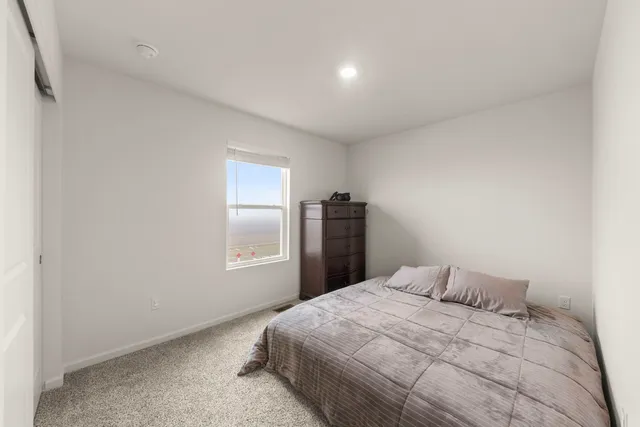 a bedroom with a bed and window