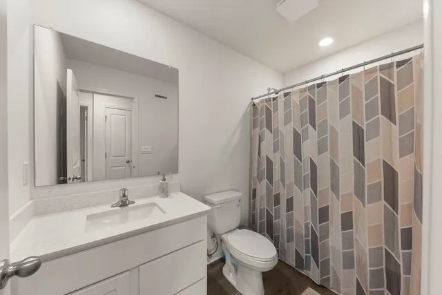 a bathroom with a sink toilet and shower