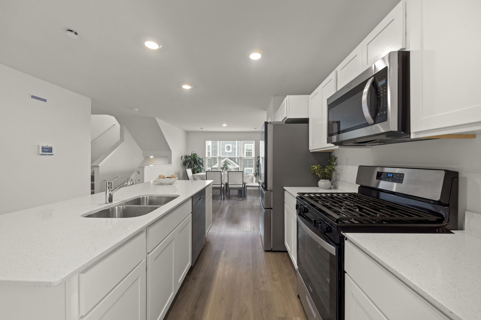 1561 Sequoia Way Pingree Grove, IL 60140 - Photo 5 of 25 a kitchen with stainless steel appliances granite countertop a sink stove and cabinets