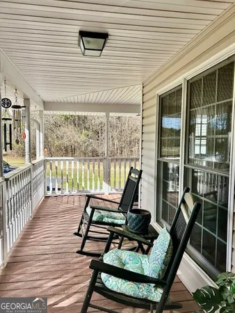 a view of a two chairs in the balcony
