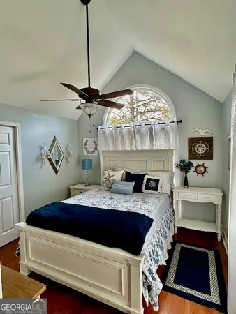 a room with a table chairs and chandelier