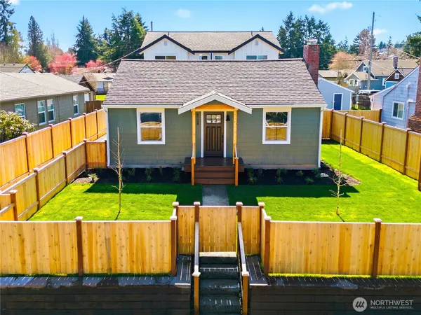 an aerial view of a house with a yard