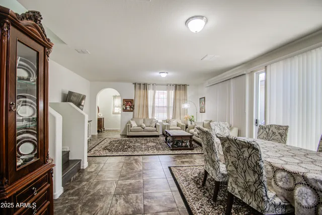 a living room with furniture floor to ceiling window and couch