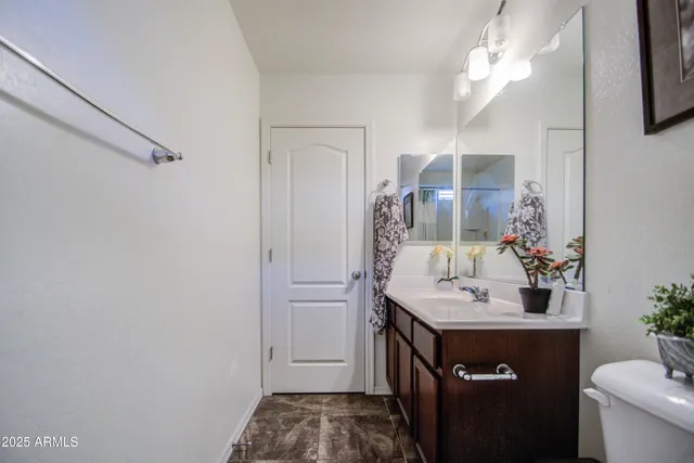 a bathroom with a sink vanity and a mirror
