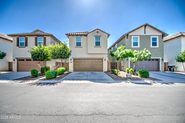 a front view of a house with a yard and a garage