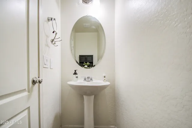 a bathroom with a sink a mirror and shower