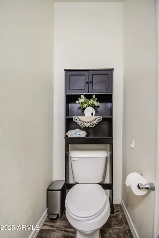 a white toilet sitting under a bathroom sink