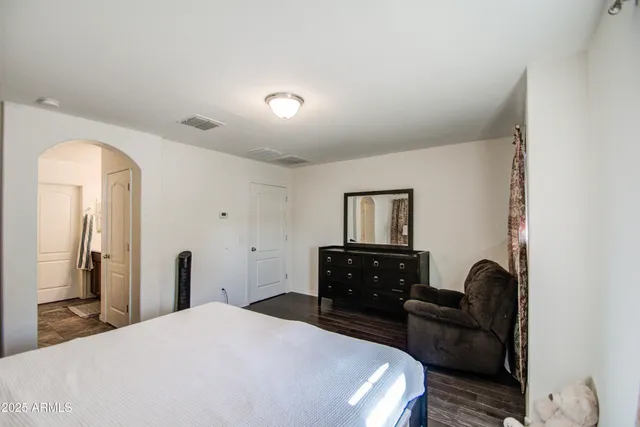 a bedroom with a bed and a dresser