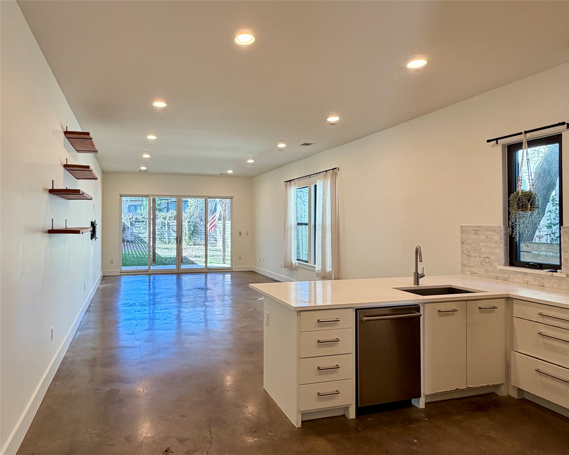 1515 Hether Street, Unit B Austin, TX 78704 - Photo 8 of 30 A well-lit open-concept living area with a functional kitchen island and ample natural illumination.