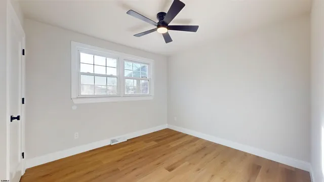 a view of room with window and hardwood floor