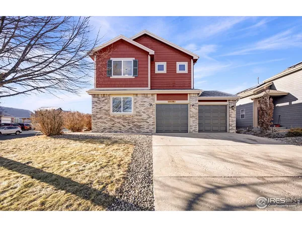 a view of a house with wooden fence