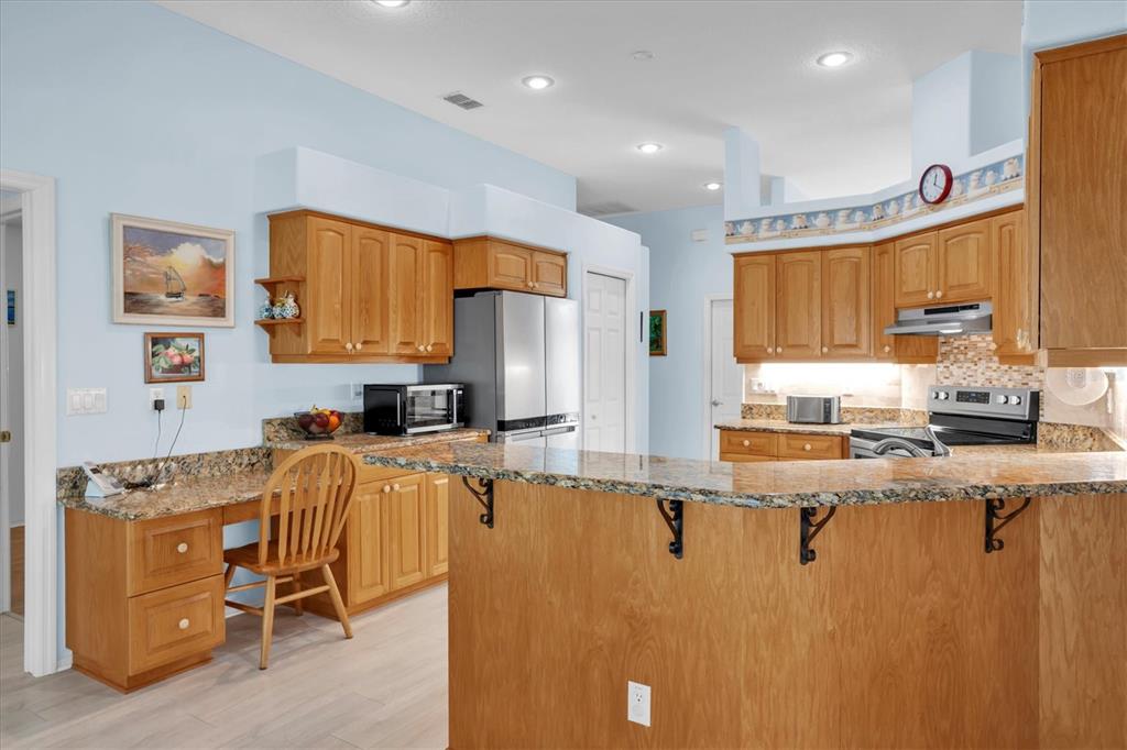 1014 Arlinbrook Drive Trinity, FL 34655 - Photo 13 of 69 a kitchen with stainless steel appliances granite countertop a sink refrigerator and microwave