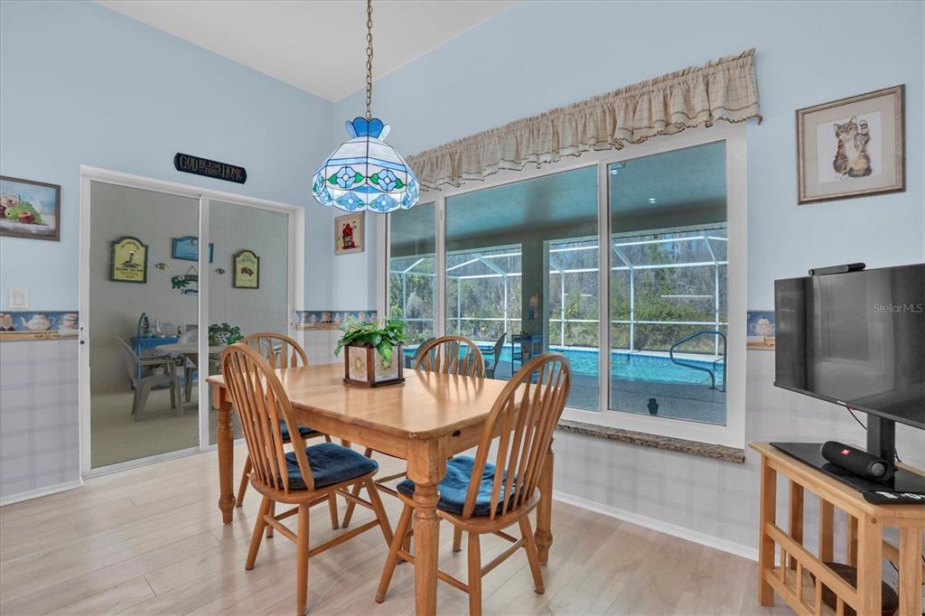 1014 Arlinbrook Drive Trinity, FL 34655 - Photo 17 of 69 a dining room with furniture a chandelier and window