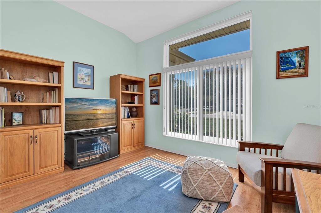 1014 Arlinbrook Drive Trinity, FL 34655 - Photo 20 of 69 a bedroom with furniture and a book shelf