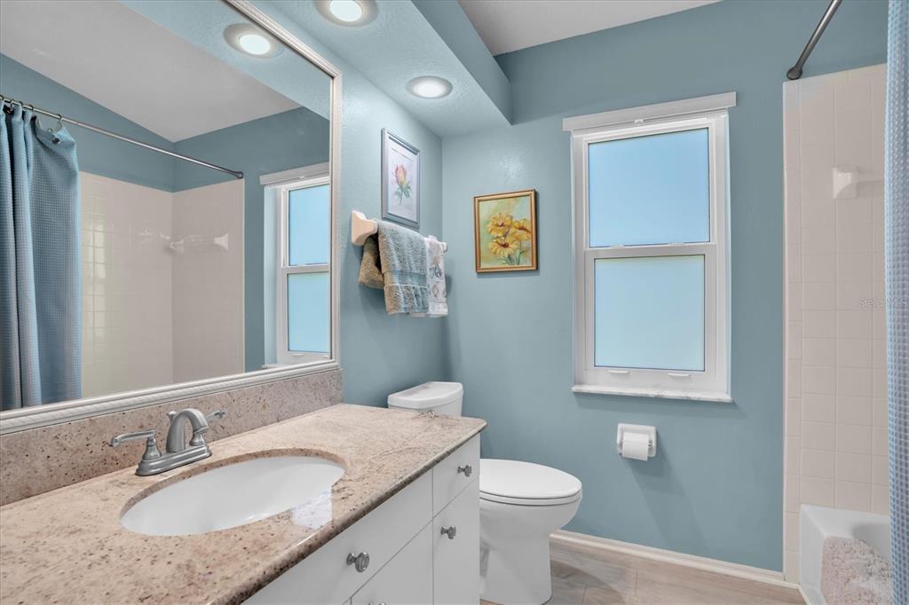 1014 Arlinbrook Drive Trinity, FL 34655 - Photo 28 of 69 a bathroom with a granite countertop sink toilet and shower