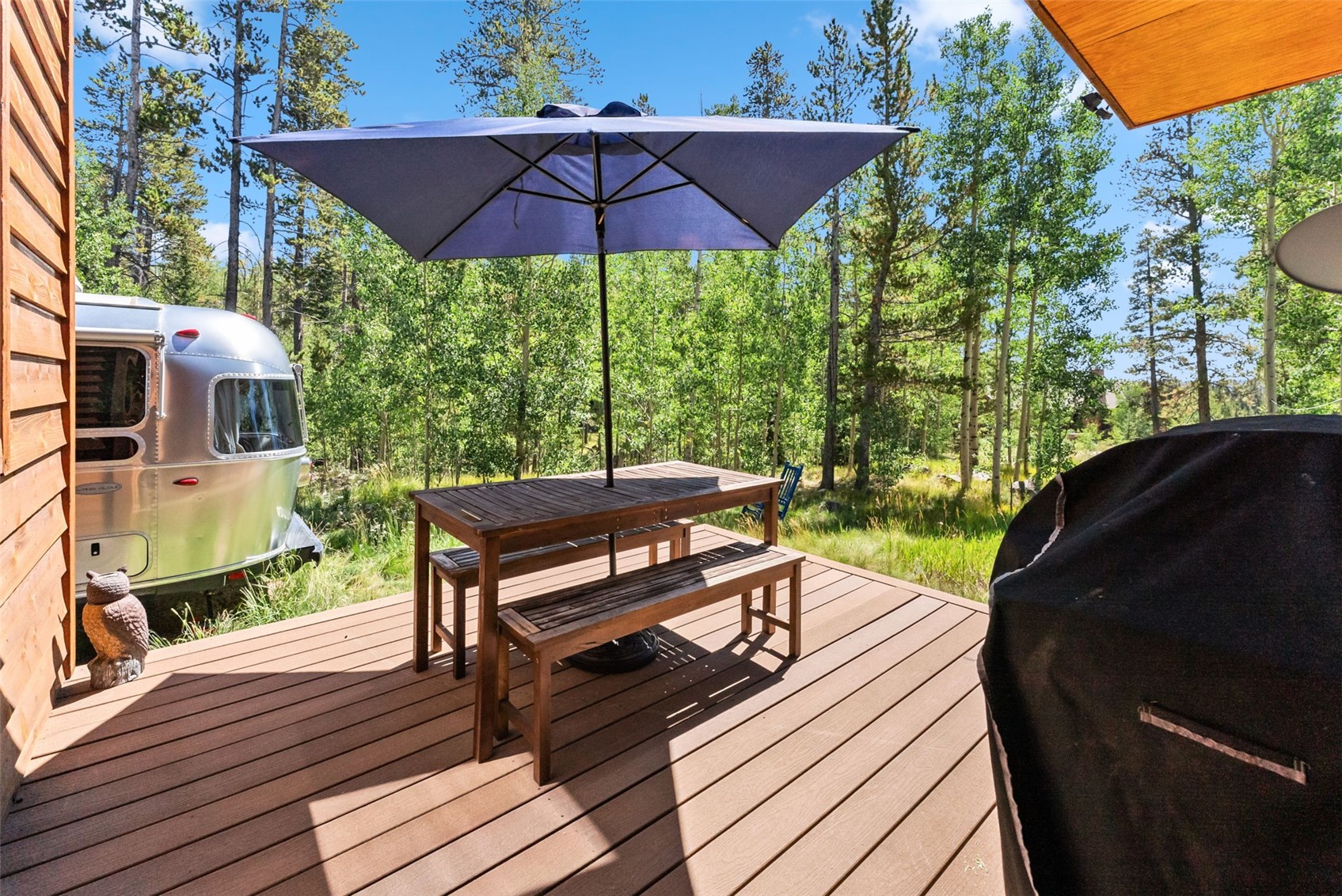 228 Glacier Ridge Road Alma, CO 80420 - Photo 46 of 50 a view of a wooden deck with chairs and an umbrella