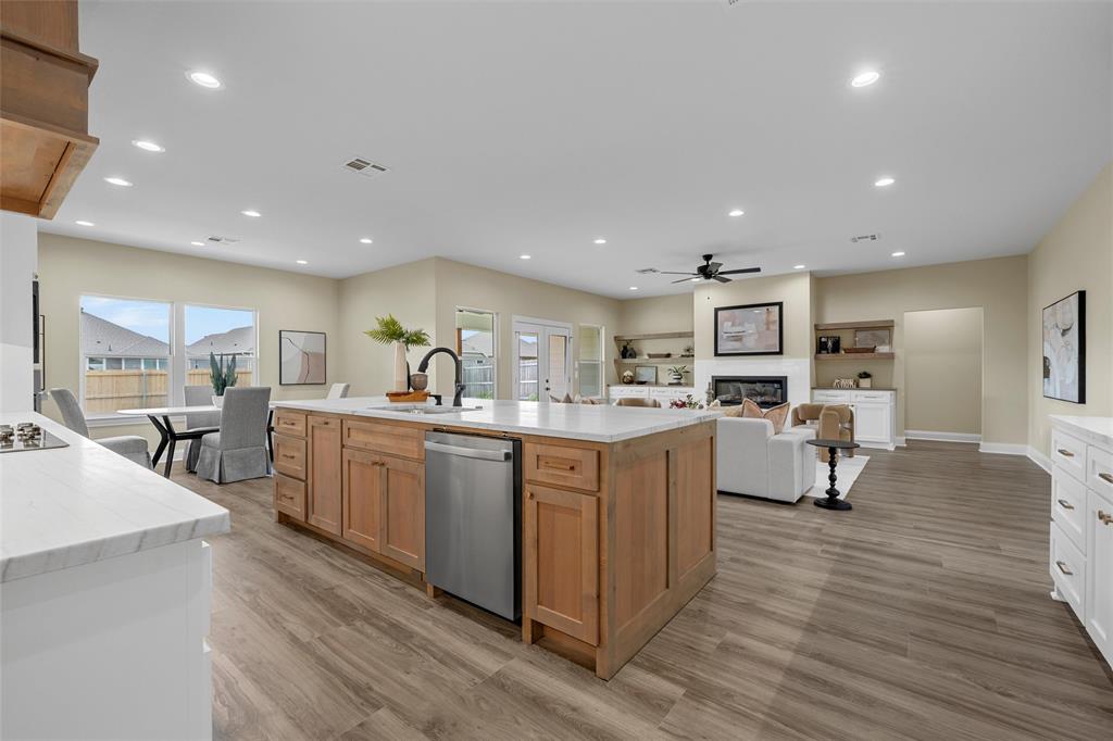 929 Northern Dancer Drive Hewitt, TX 76643 - Photo 7 of 36 a kitchen with sink cabinets and wooden floor