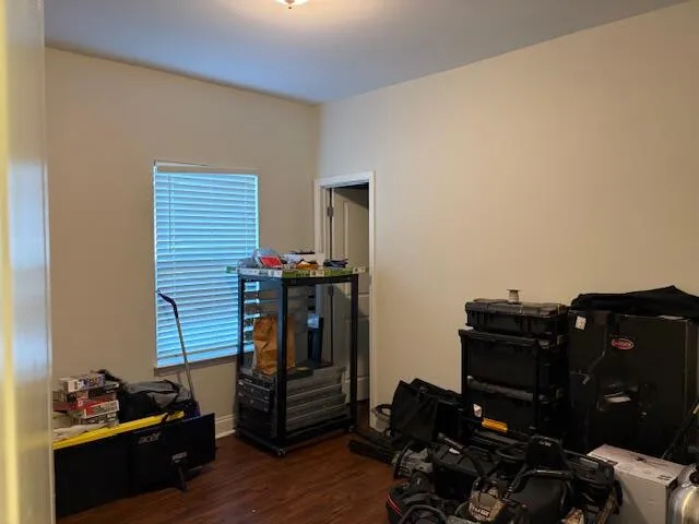 a view of a workspace with furniture and wooden floor
