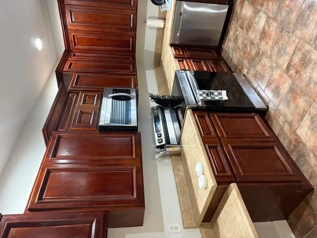 a kitchen with a refrigerator and a sink
