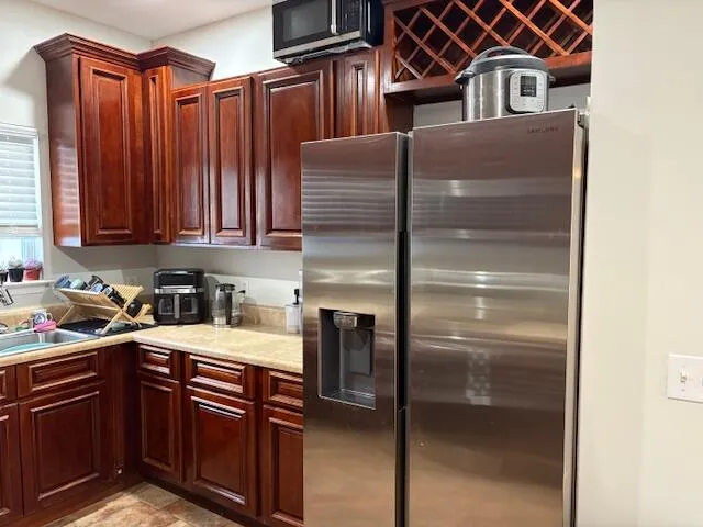 a bedroom with a bed a chair and a window