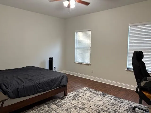 a bathroom with a granite countertop sink a toilet and a mirror