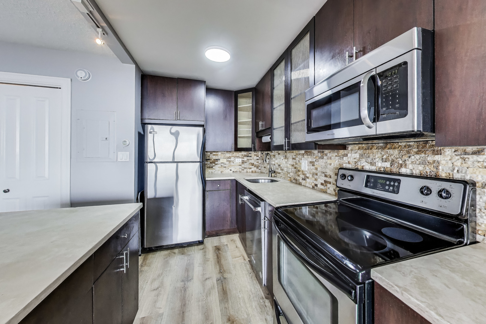 2930 North Sheridan Road, Unit 2111 Chicago, IL 60657 - Photo 12 of 31 a kitchen with a stove microwave and refrigerator