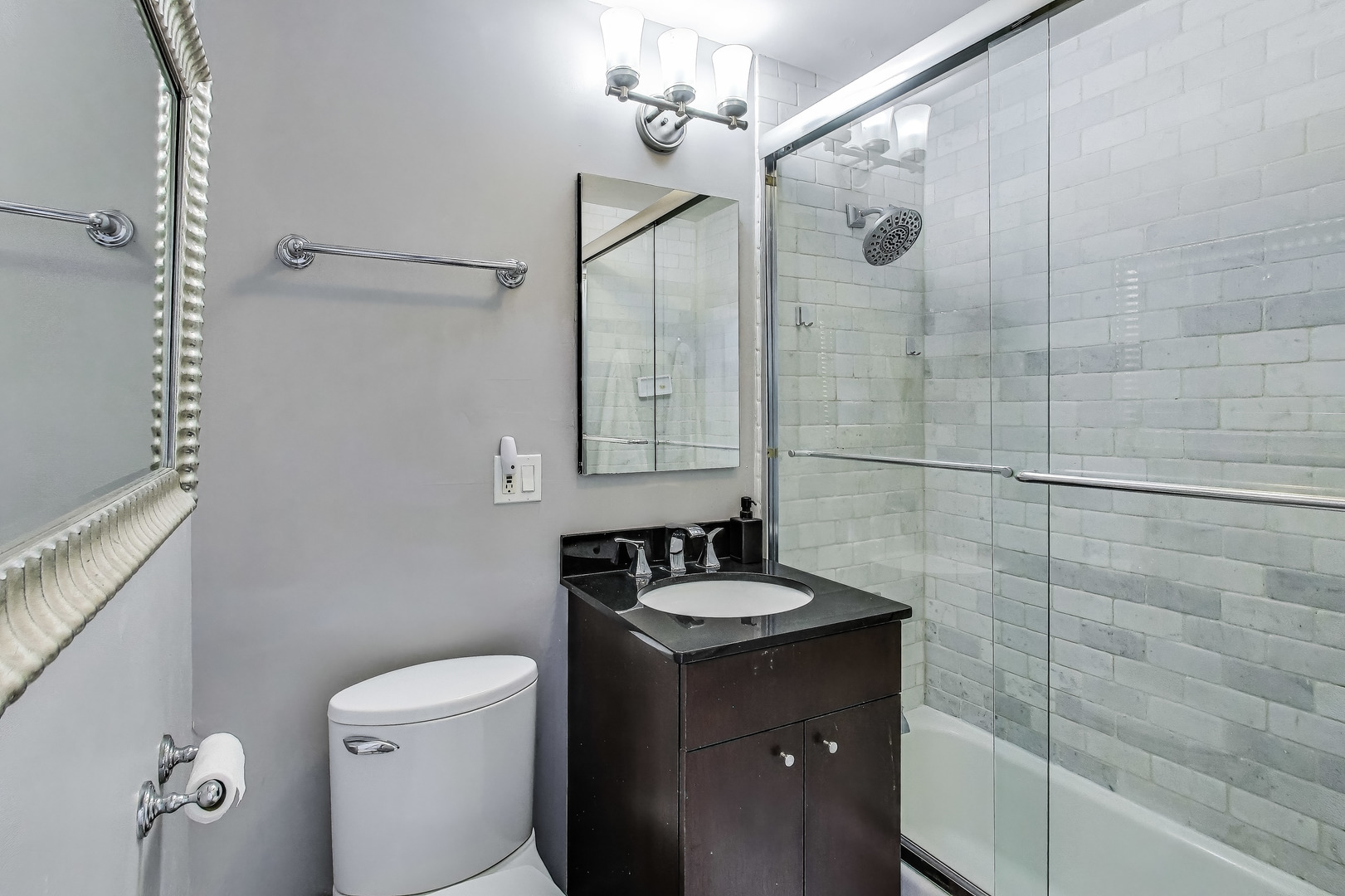 2930 North Sheridan Road, Unit 2111 Chicago, IL 60657 - Photo 16 of 31 a bathroom with a sink a toilet and shower