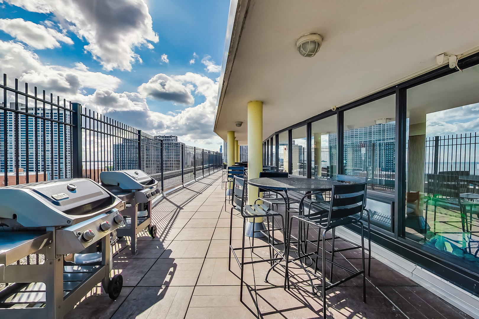 2930 North Sheridan Road, Unit 2111 Chicago, IL 60657 - Photo 20 of 31 a view of a patio with dining table and chairs